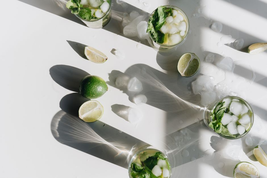 A berry mojito mocktail with muddled berries, mint, and lime
