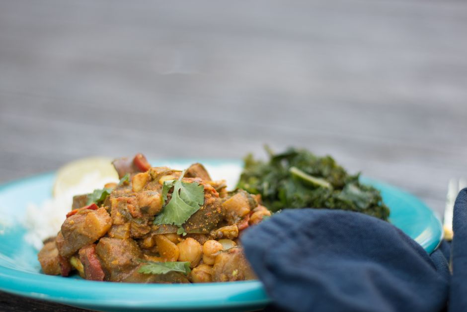 A bowl of chickpea curry over rice, garnished with cilantro