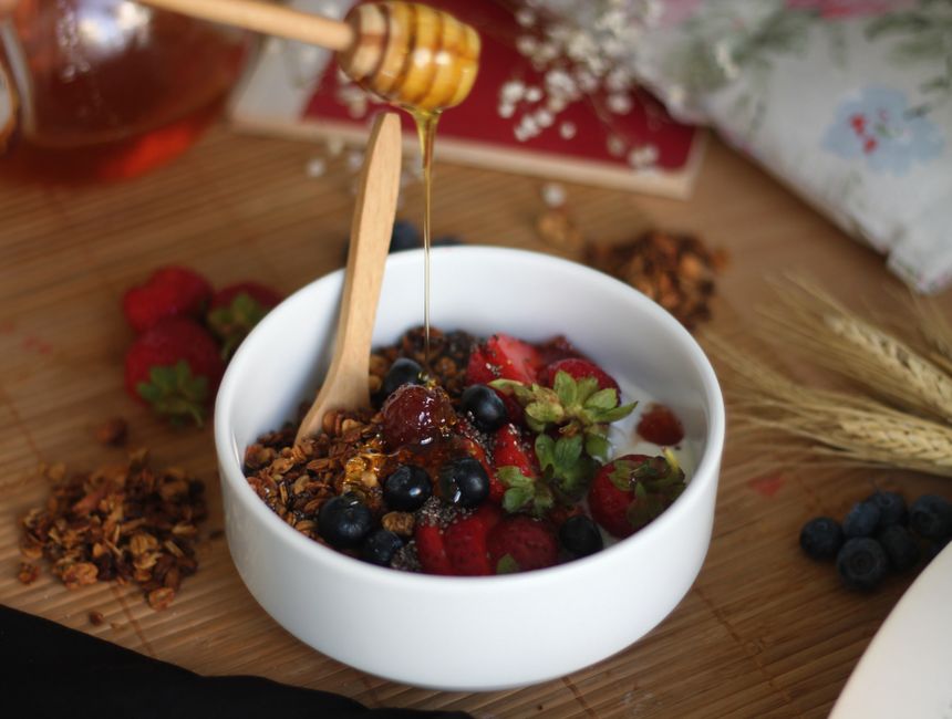 A creamy cottage cheese bowl topped with fresh berries, granola, and a drizzle of honey