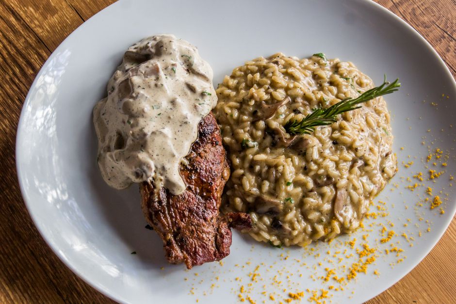 A bowl of creamy mushroom risotto with herbs and Parmesan