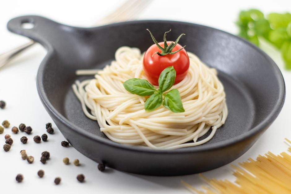 Creamy tomato basil pasta simmering in a skillet