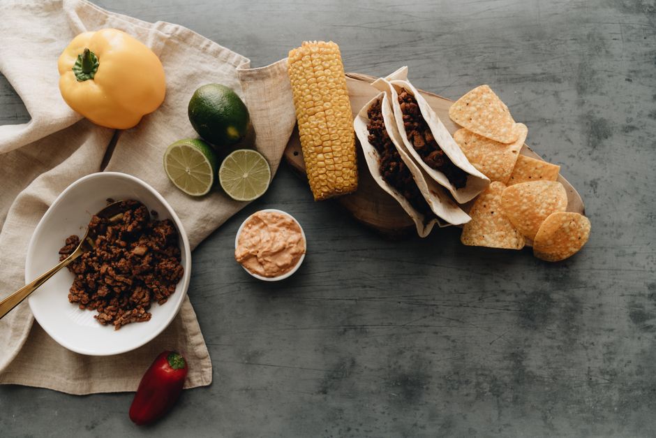 Top view of Mexican tacos with ingredients like corn and lime, perfect for a delicious meal.