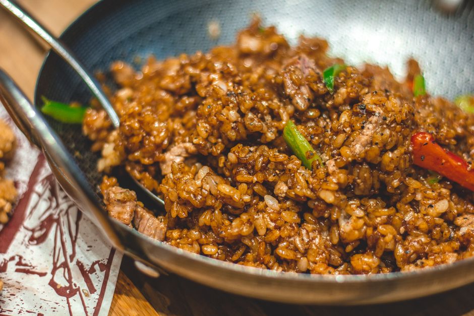Vegetable fried rice with egg and green onion in a wok
