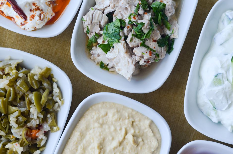 Greek chicken bowl with rice, cucumber, tomato, and tzatziki