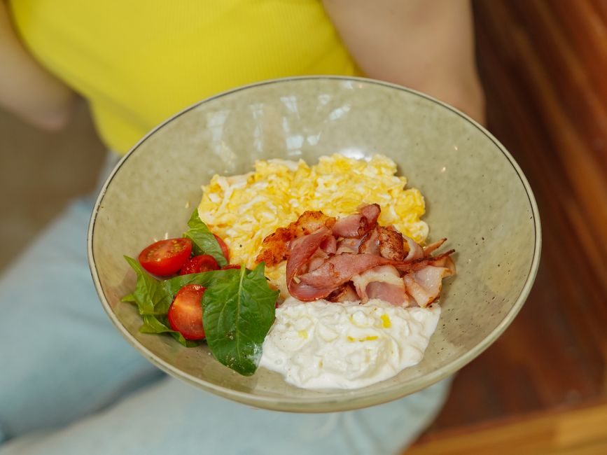 breakfast bowl with scrambled eggs cottage cheese tomatoes and fresh herbs