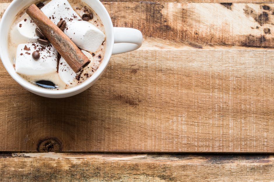 A mug of creamy hot chocolate topped with marshmallows