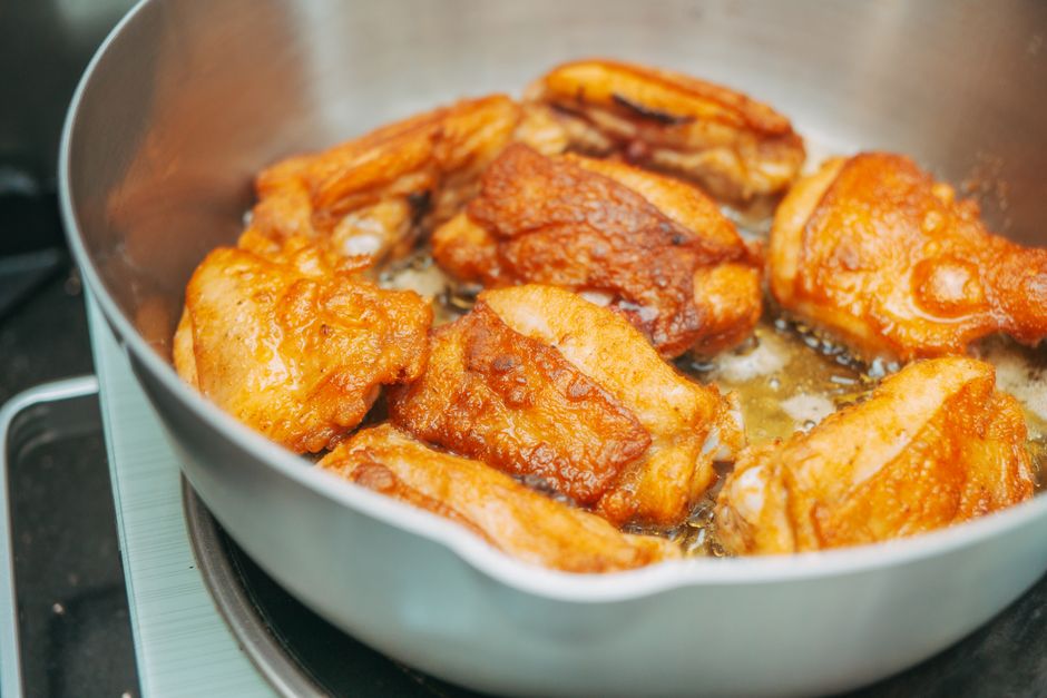 Sticky honey garlic chicken thighs glazed in a skillet