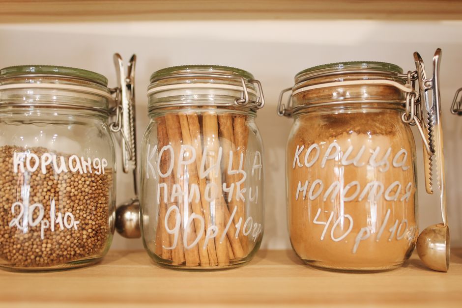 Bunches of fresh herbs stored upright in jars of water