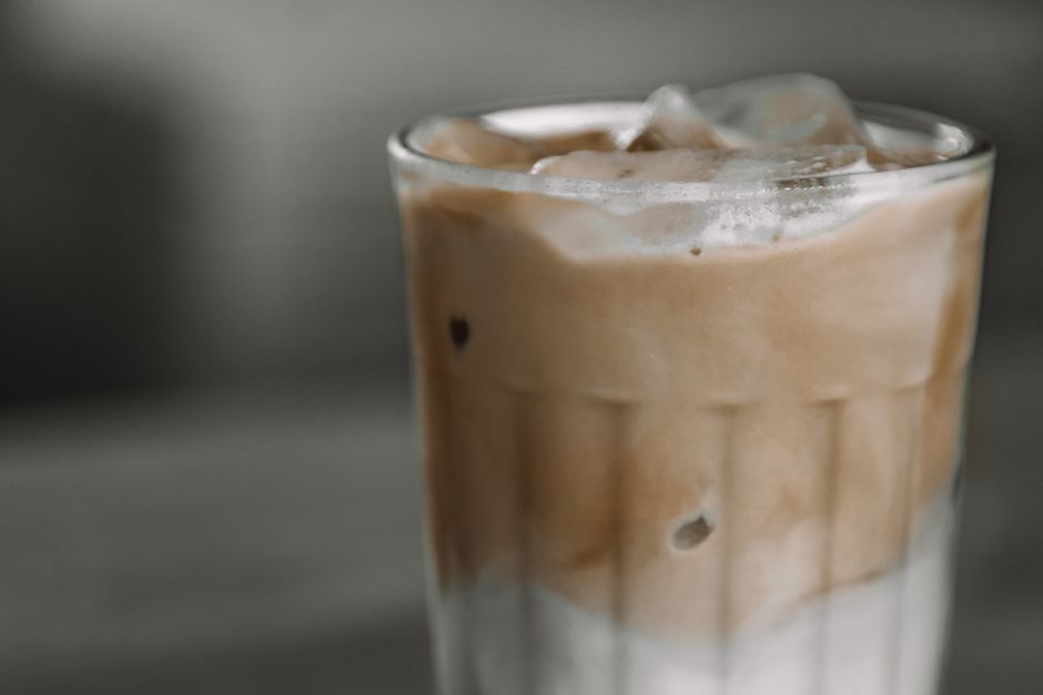 An iced brown sugar oat milk latte with cinnamon in a glass