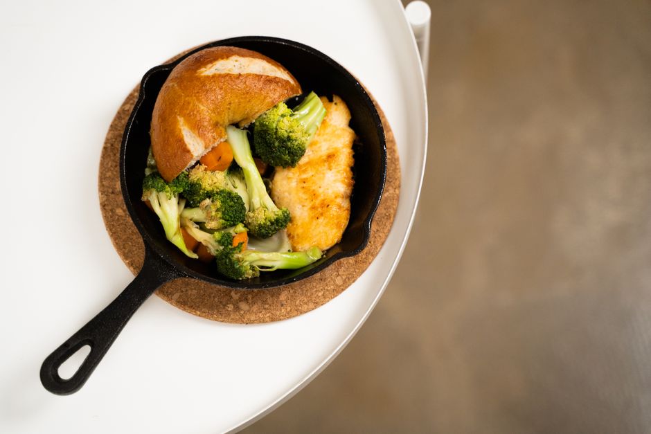 Golden garlic butter chicken with vegetables in a cast iron skillet