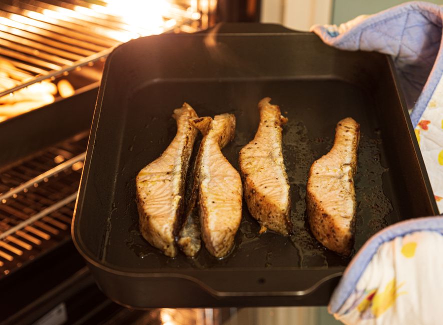 Salmon fillets roasted with broccoli and tomatoes on a sheet pan