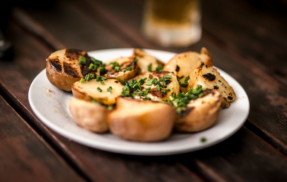 plated crispy smashed potatoes garnished with herbs