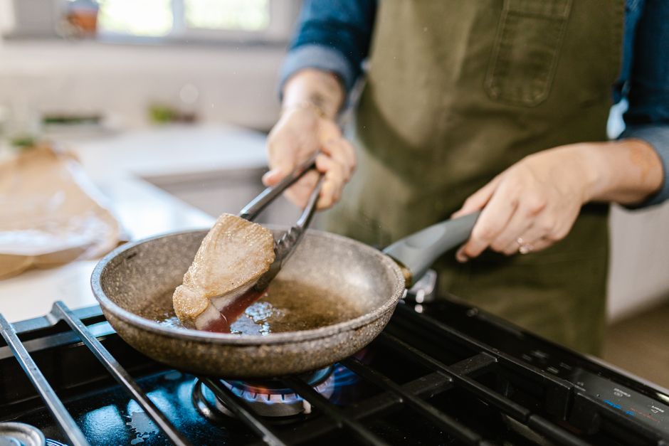 Chicken searing in a skillet for bistek