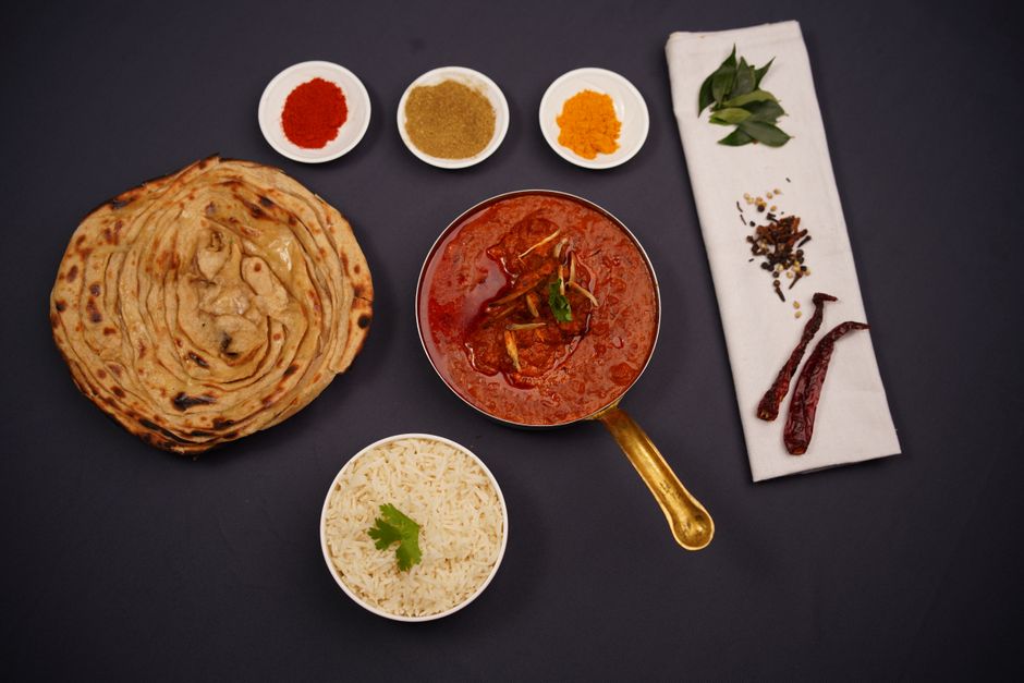 naan bread and basmati rice served alongside chicken tikka masala
