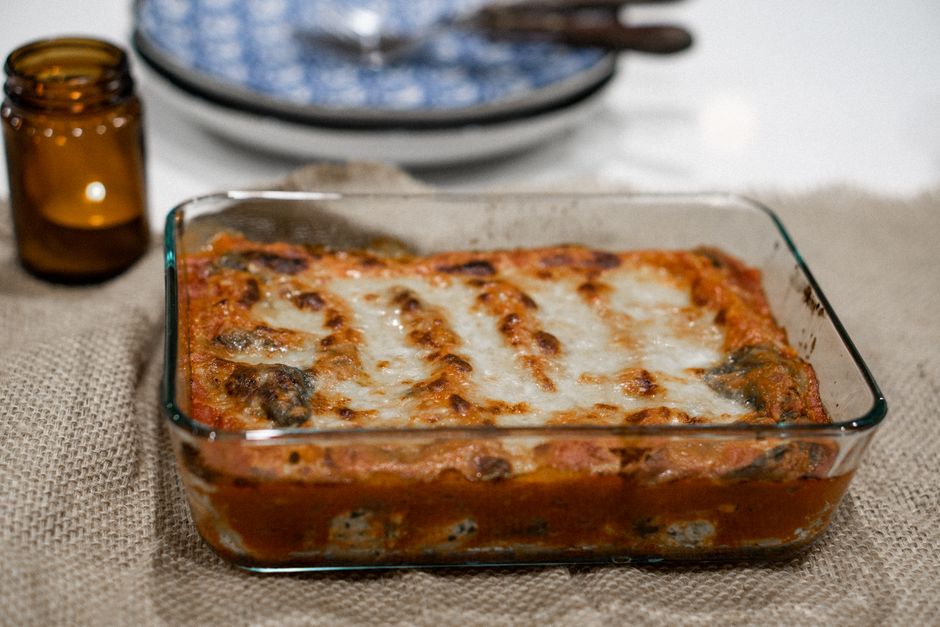 Baked dumpling lasagna casserole with melted cheese on top