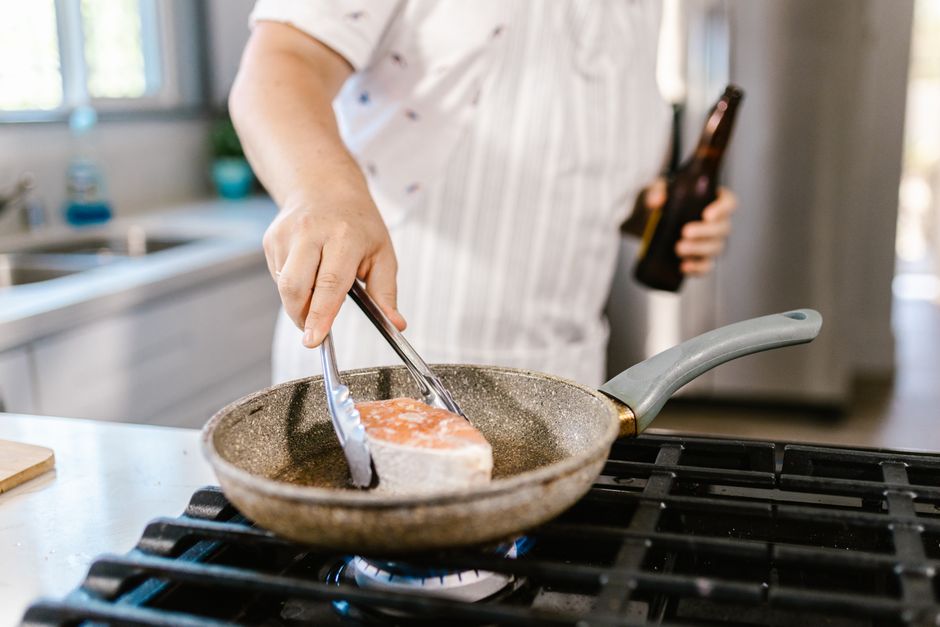 Salmon fillets searing skin-side up in a hot skillet