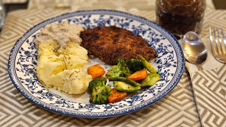 Marry Me Chicken plated with mashed potatoes and a side of greens