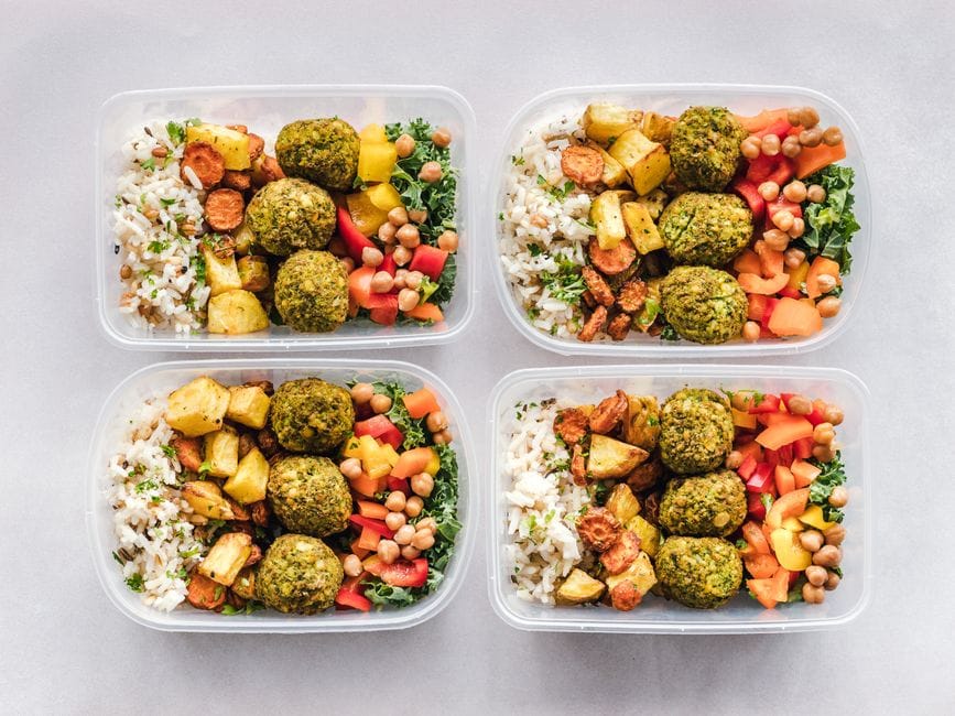 Meal prep containers filled with healthy lunch ingredients