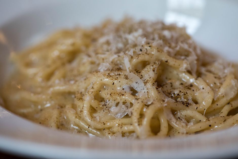 Close-up of carbonara pasta twirled on a fork