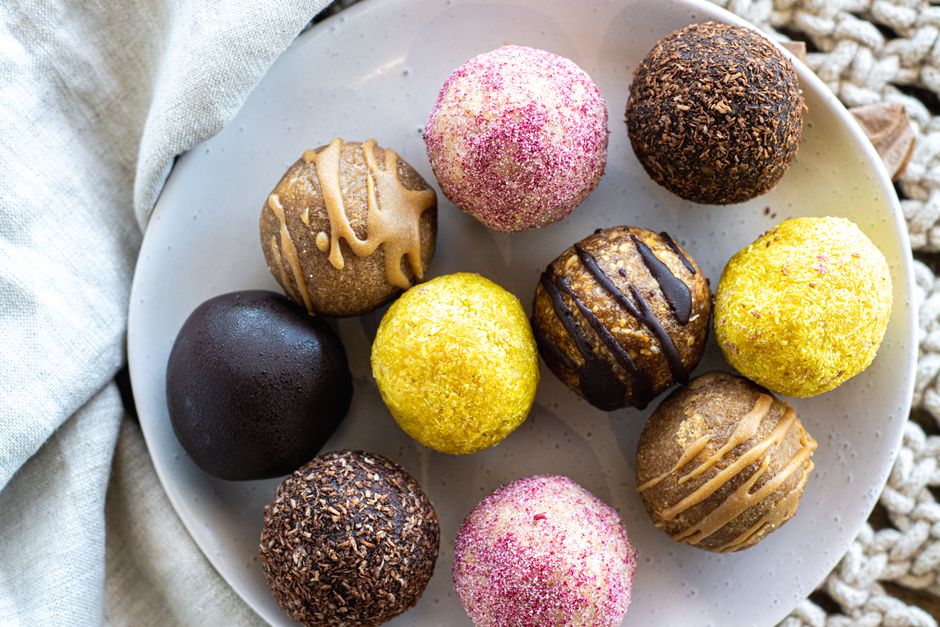 Stack of no-bake high-protein energy balls on a plate