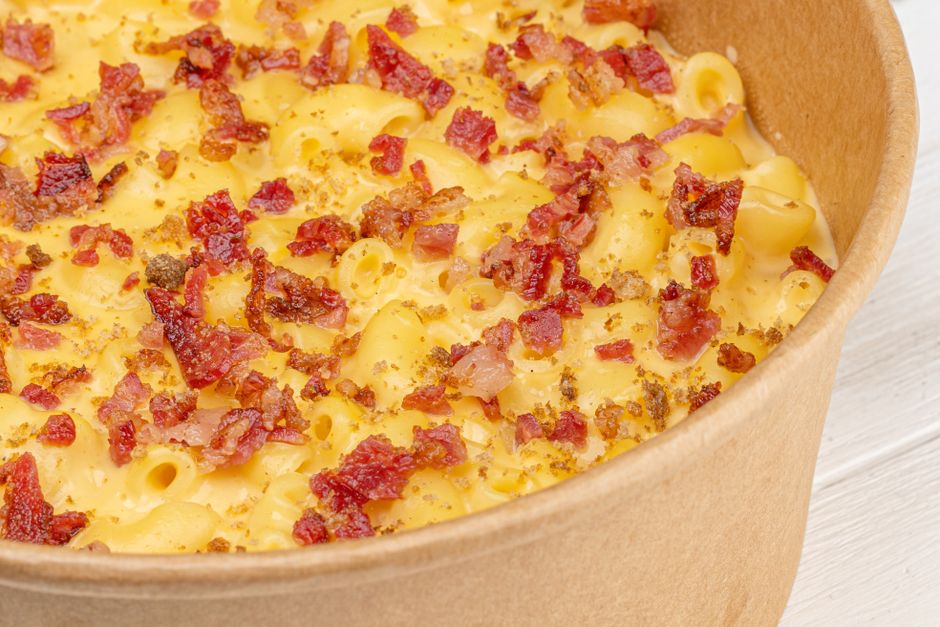 Bowl of creamy high-protein mac and cheese with a spoon
