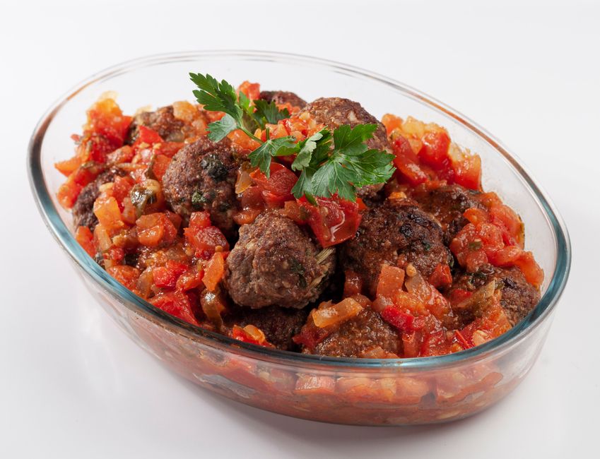 Tray of baked turkey meatballs simmering in marinara sauce