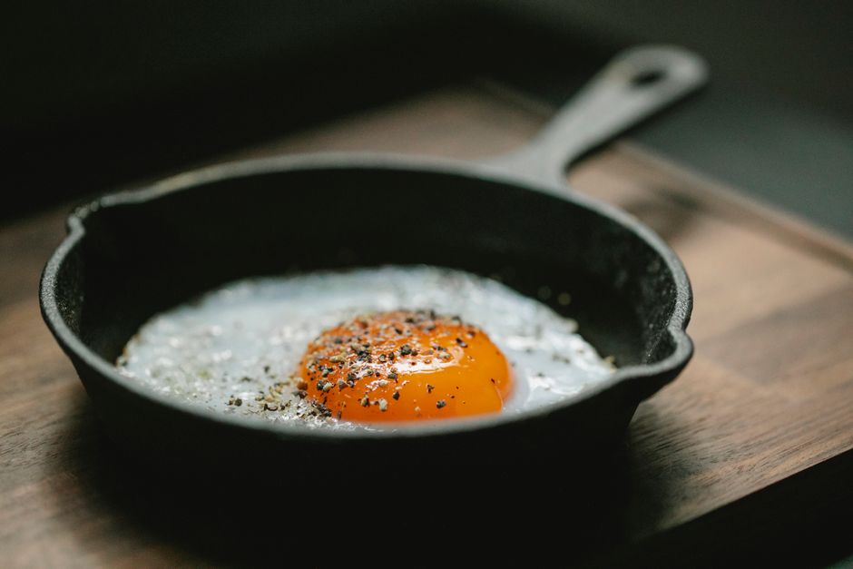 Fried rice with chicken, egg, and vegetables in a large skillet